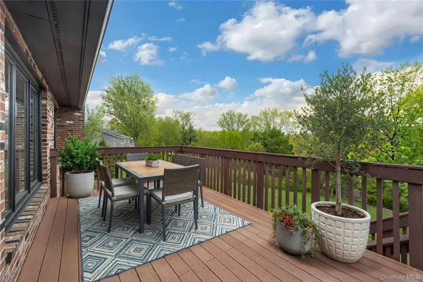 a view of a deck with furniture and trees