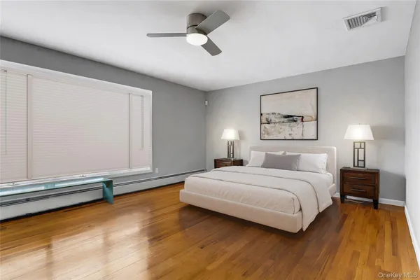 a bedroom with a bed and a ceiling fan