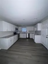 a view of kitchen and wooden floor