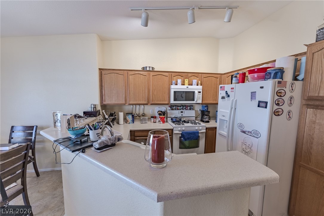 4994 Mascaro Drive Las Vegas, NV 89122 - Photo 6 of 30 A well-equipped kitchen features a functional layout with ample counter space and overhead track lighting.