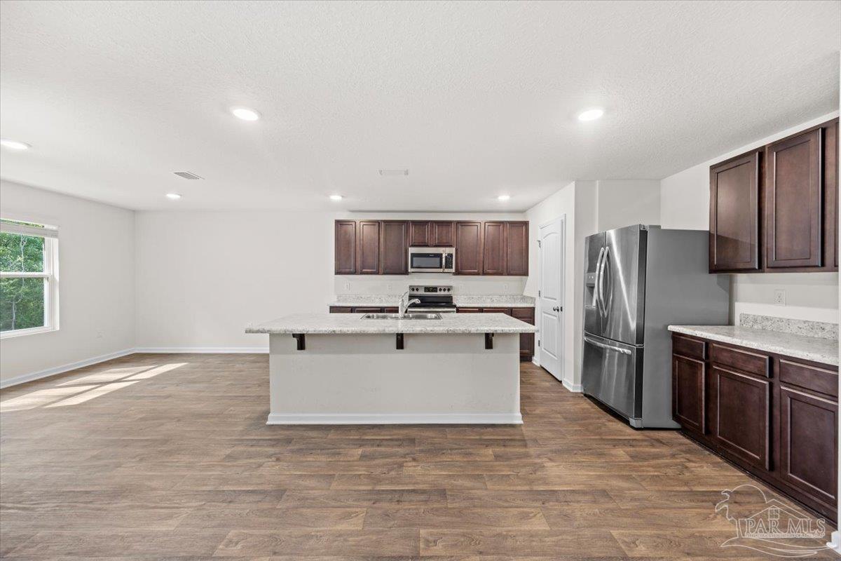 4666 Perception Circle Milton, FL 32570 - Photo 14 of 36 a view of kitchen with sink microwave and refrigerator