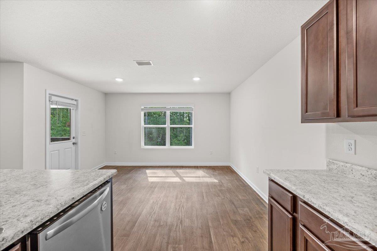 4666 Perception Circle Milton, FL 32570 - Photo 17 of 36 a view of a kitchen with granite countertop a sink and a stove