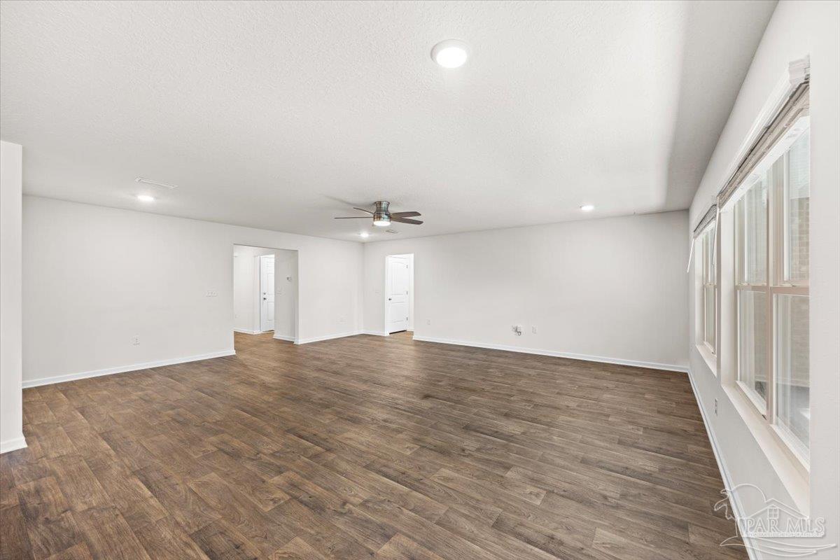 4666 Perception Circle Milton, FL 32570 - Photo 18 of 36 an empty room with wooden floor and windows
