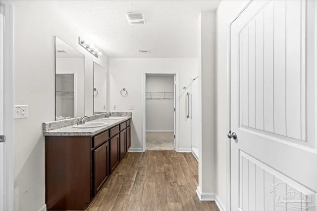 a view of bathroom with a sink and mirror