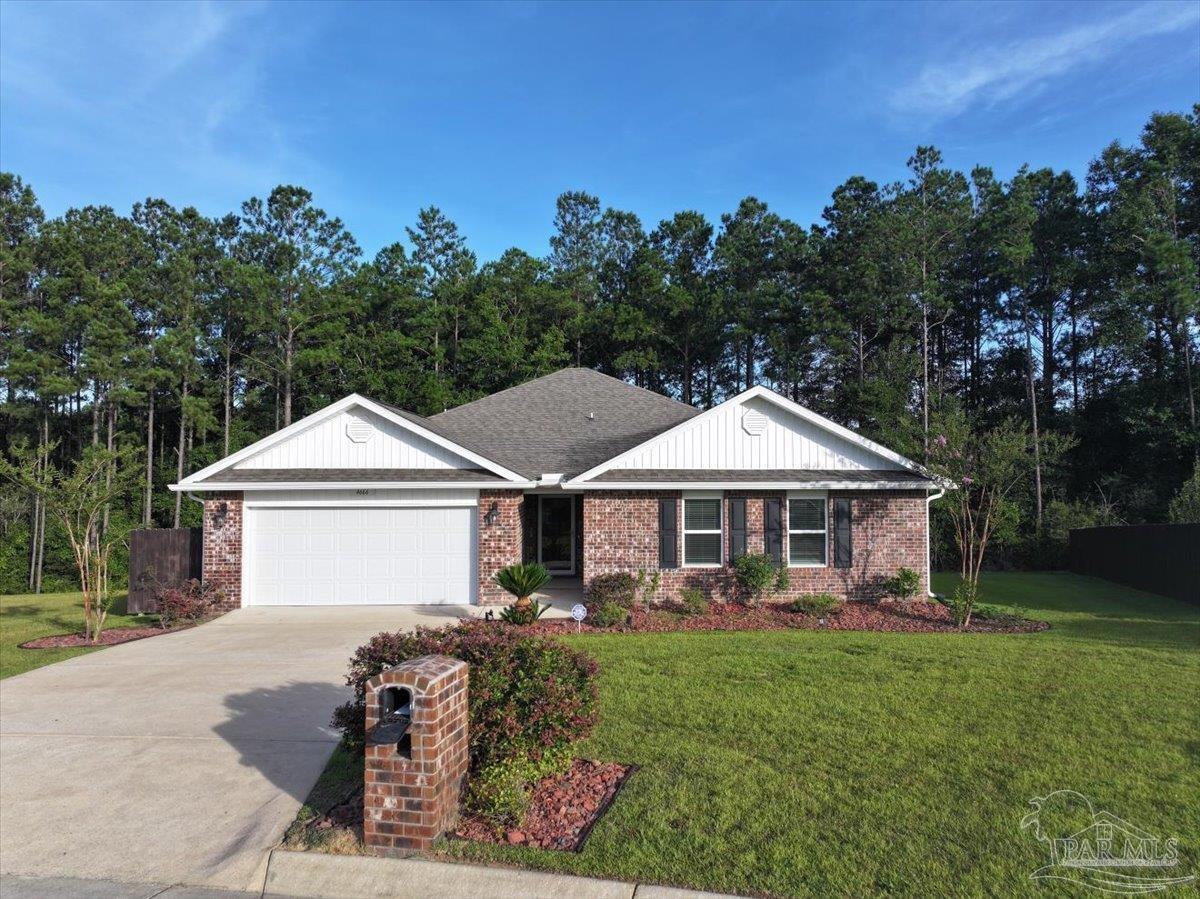 4666 Perception Circle Milton, FL 32570 - Photo 34 of 36 a front view of a house with garden