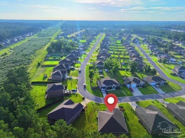 an aerial view of multiple house with a yard