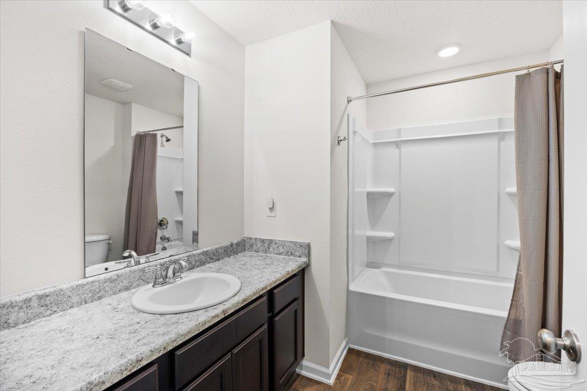 4666 Perception Circle Milton, FL 32570 - Photo 6 of 36 a bathroom with a granite countertop sink mirror and a bathtub