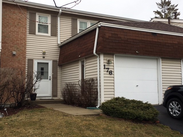 a black car parked in front of a house