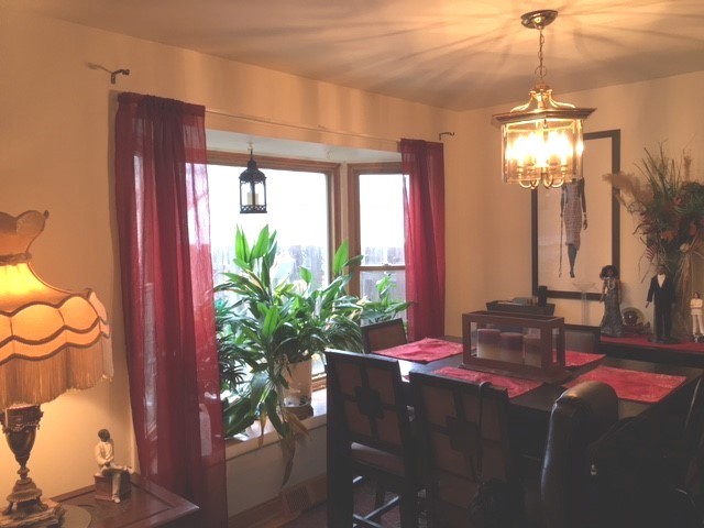 176 Jeffrey Lane Bolingbrook, IL 60440 - Photo 5 of 12 a dining room with furniture a chandelier and window
