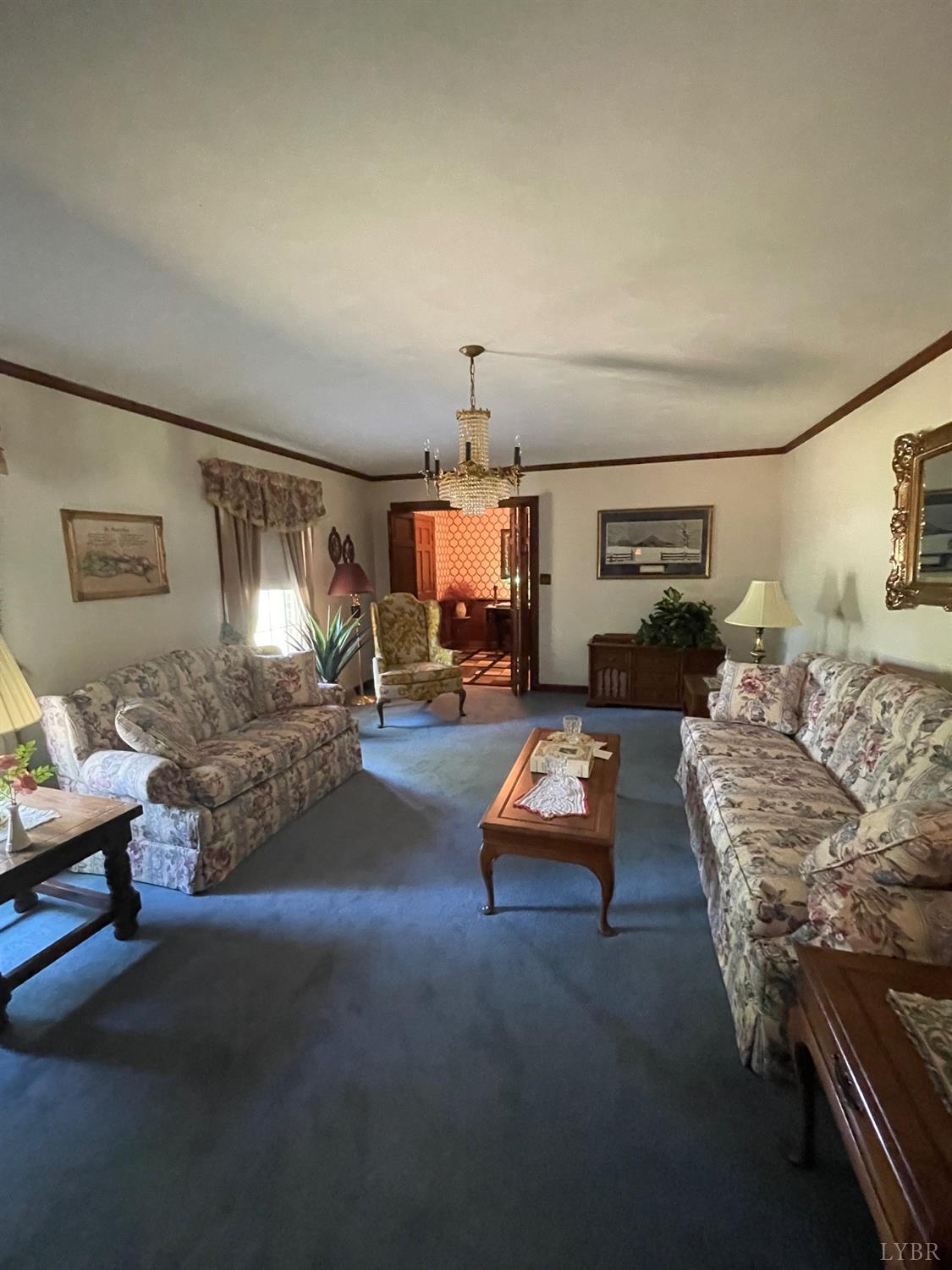389 Homeplace Road Rustburg, VA 24588 - Photo 4 of 20 a living room with furniture and a chandelier