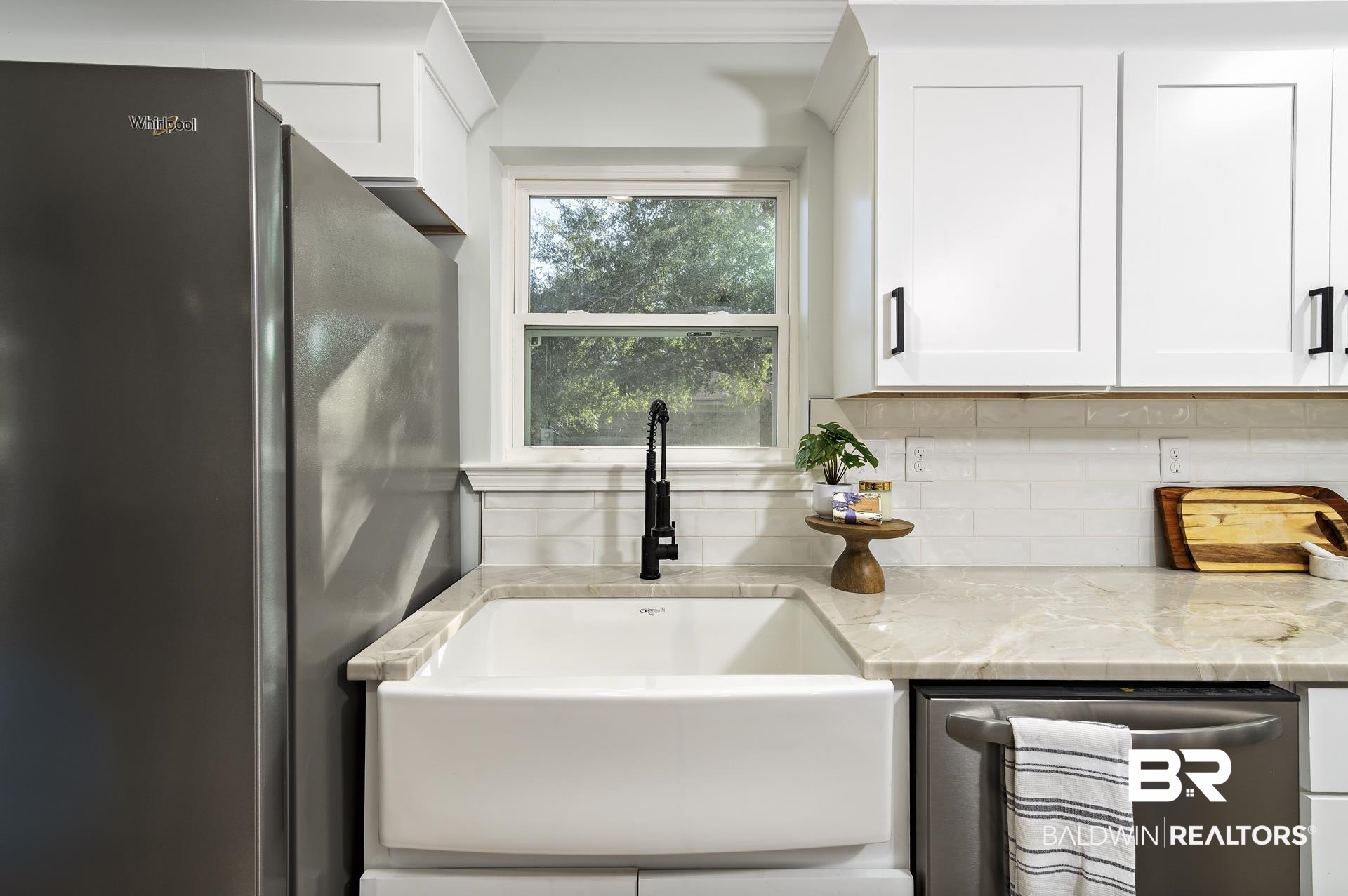 6001 Camp Halls Mill Road Mobile, AL 36619 - Photo 16 of 52 Kitchen with stainless steel appliances, light stone countertops, decorative backsplash, and white cabinetry
