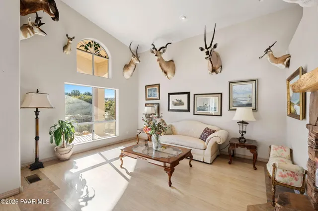 a bedroom with a bed and a flat tv screen on dresser