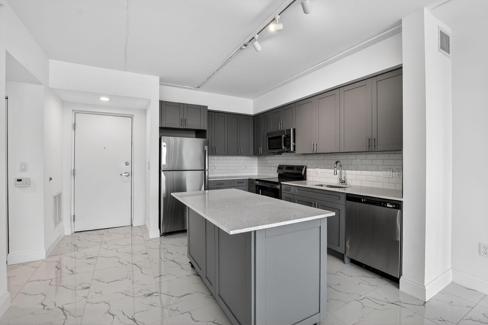 350 West Hidden Valley Boulevard, Unit 107 Boca Raton, FL 33487 - Photo 2 of 26 a kitchen with stainless steel appliances granite countertop a sink stove and refrigerator