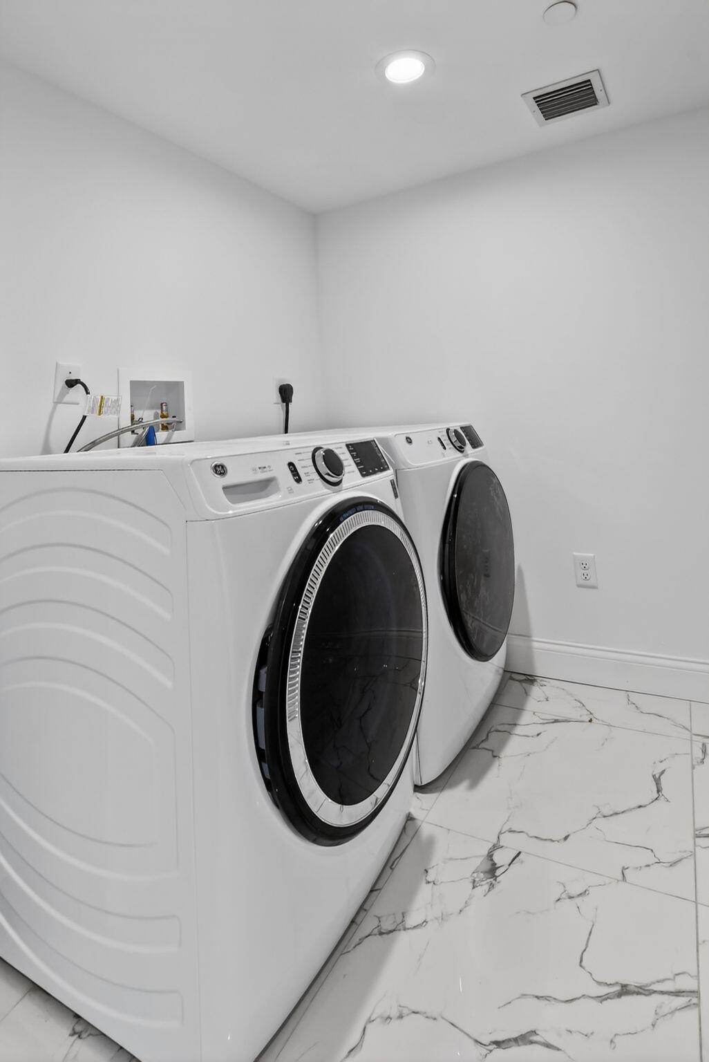 350 West Hidden Valley Boulevard, Unit 107 Boca Raton, FL 33487 - Photo 5 of 26 a utility room with dryer and washer