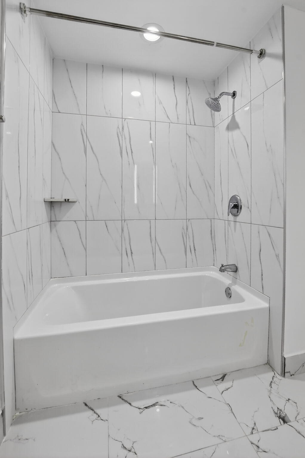 350 West Hidden Valley Boulevard, Unit 107 Boca Raton, FL 33487 - Photo 9 of 26 a bathroom with a bathtub and shower