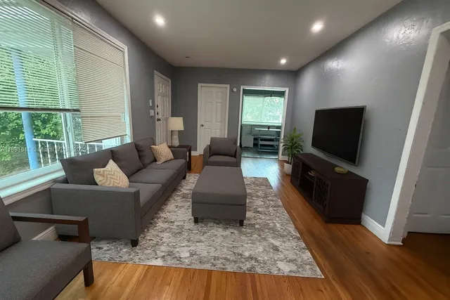 a living room with furniture and a flat screen tv