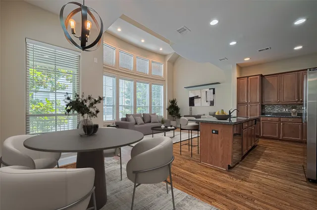 a kitchen with stainless steel appliances granite countertop a stove a table and chairs