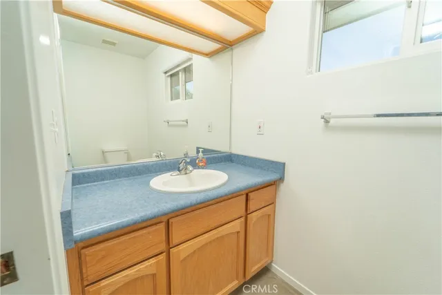 a white toilet sitting next to a white wall