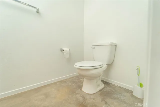 a view of a kitchen with wooden floor and a window