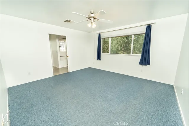an empty room with windows and closet