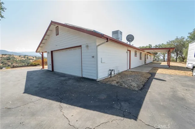 a view of a house with a yard and garage