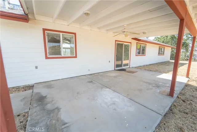 a view of a house with a yard covered in snow