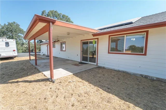 en bedroom with a bed a window and painting on the wall