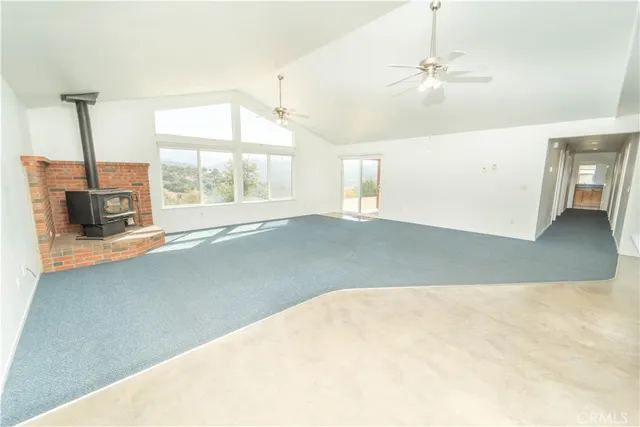 a view of empty room with a kitchen