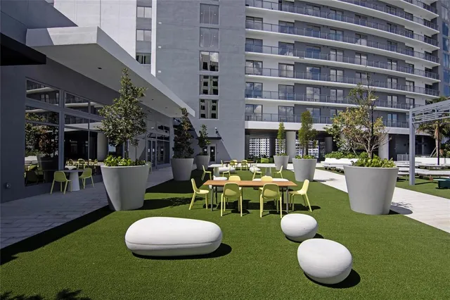 a view of an outside dining room with chairs and tables