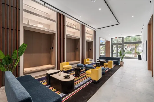 a dining room with furniture and a large window