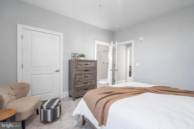 a bedroom with a bed and a couch