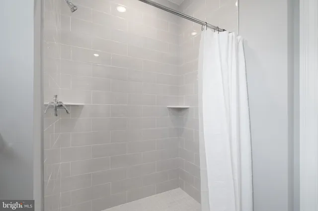 a bathroom with a shower and a shower