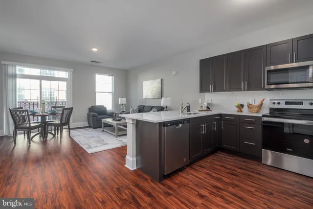 a kitchen with wooden floors and wooden cabinets