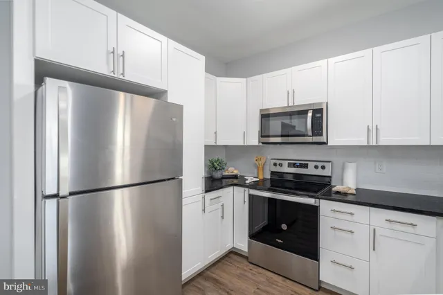a white refrigerator freezer sitting in a kitchen