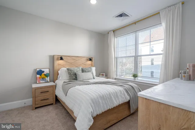 a bedroom with a bed and a window