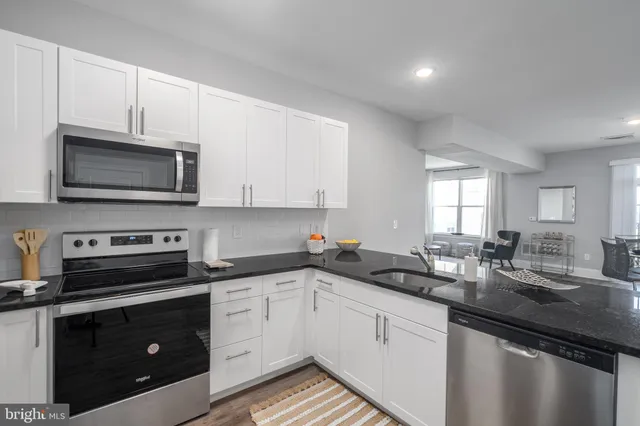 a kitchen with a sink stove and microwave