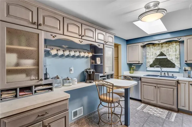 a kitchen with a sink cabinets and window