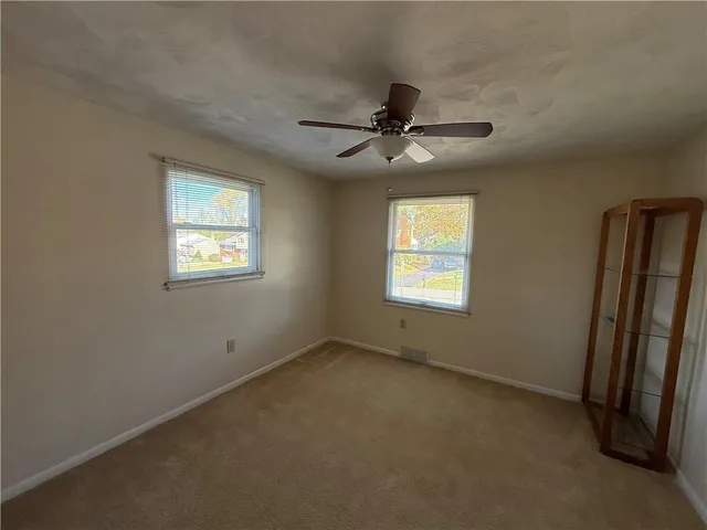 a view of room with a ceiling fan and window