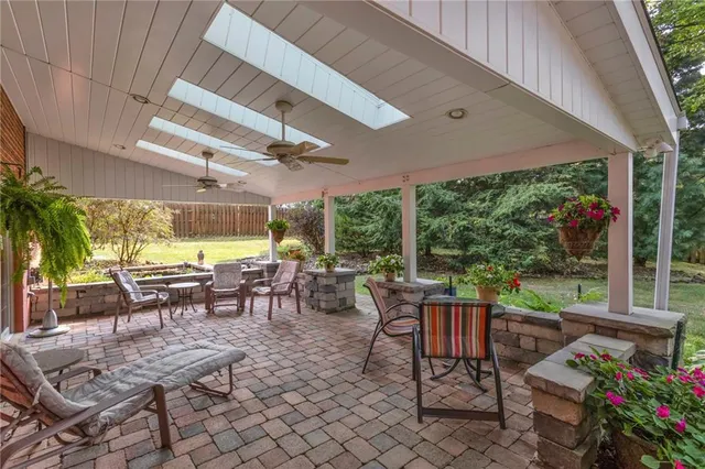 a outdoor space with lots of tables a garden view and chairs