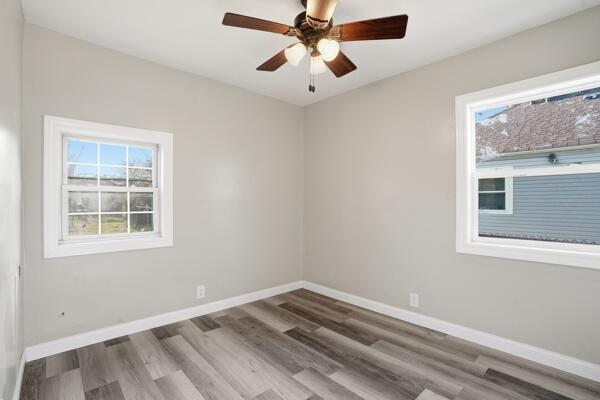 560 Ralston Street Gary, IN 46406 - Photo 6 of 11 an empty room with a window and a ceiling fan