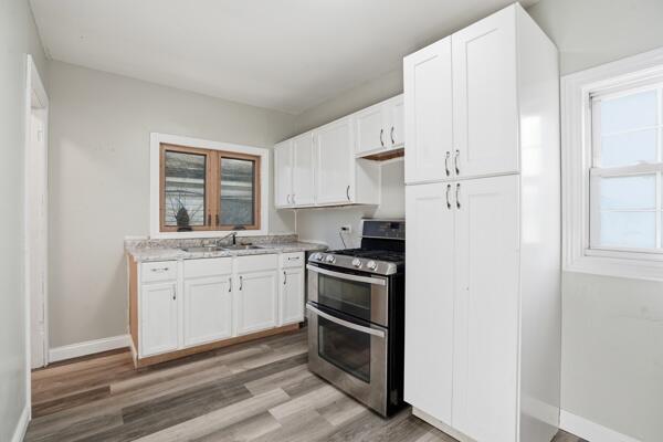 560 Ralston Street Gary, IN 46406 - Photo 7 of 11 a kitchen with granite countertop white cabinets and white appliances