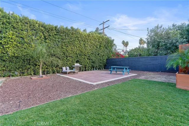 a view of a backyard with sitting area