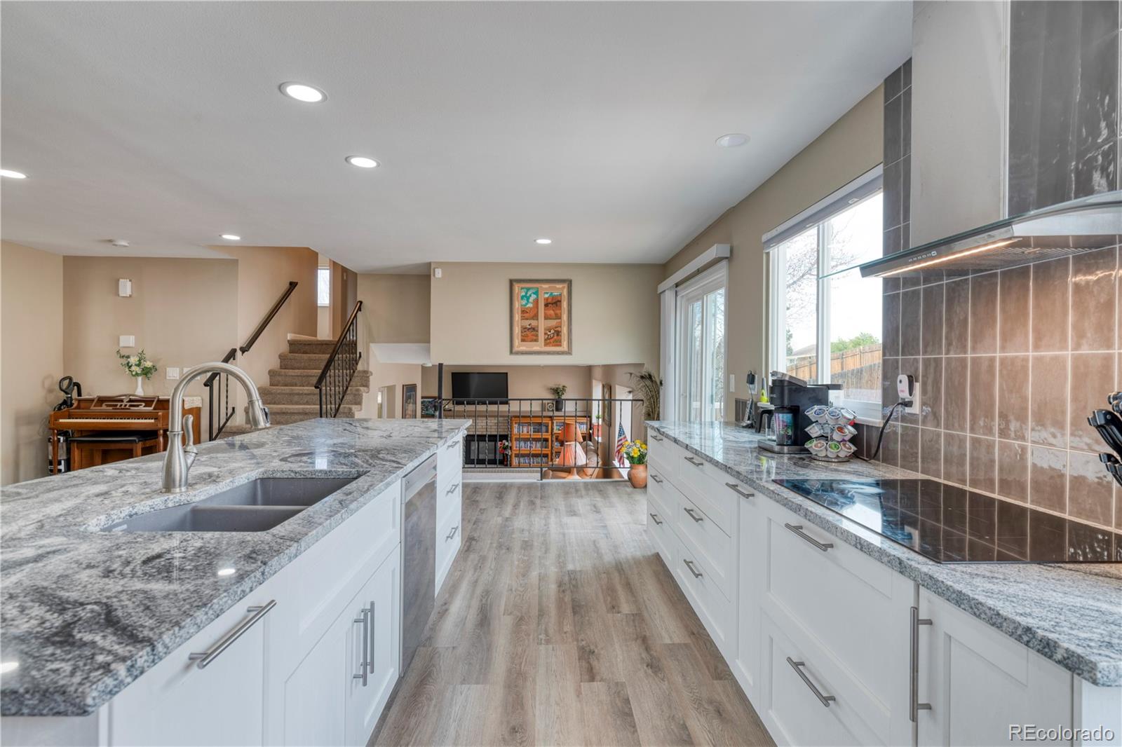 6723 East Rustic Drive Parker, CO 80138 - Photo 11 of 32 a large kitchen with stainless steel appliances lots of counter space and a sink