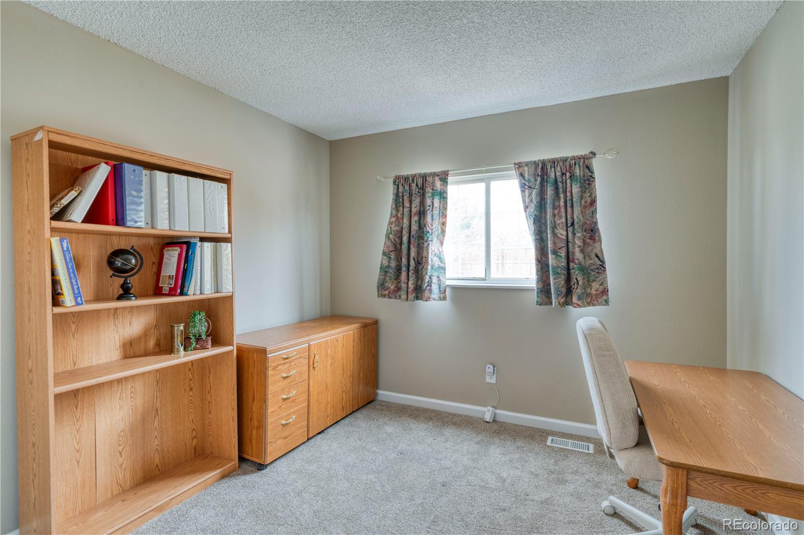 6723 East Rustic Drive Parker, CO 80138 - Photo 13 of 32 a room with furniture and a window