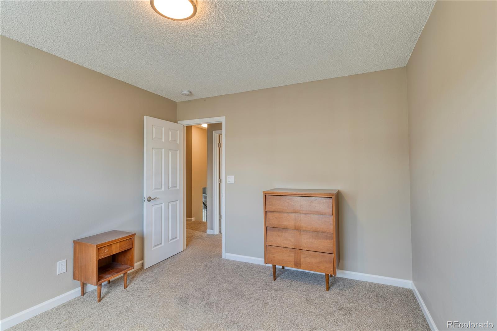 6723 East Rustic Drive Parker, CO 80138 - Photo 15 of 32 an empty room with a dresser and a window