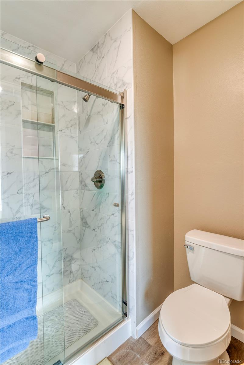 6723 East Rustic Drive Parker, CO 80138 - Photo 20 of 32 a white toilet sitting next to a bathroom