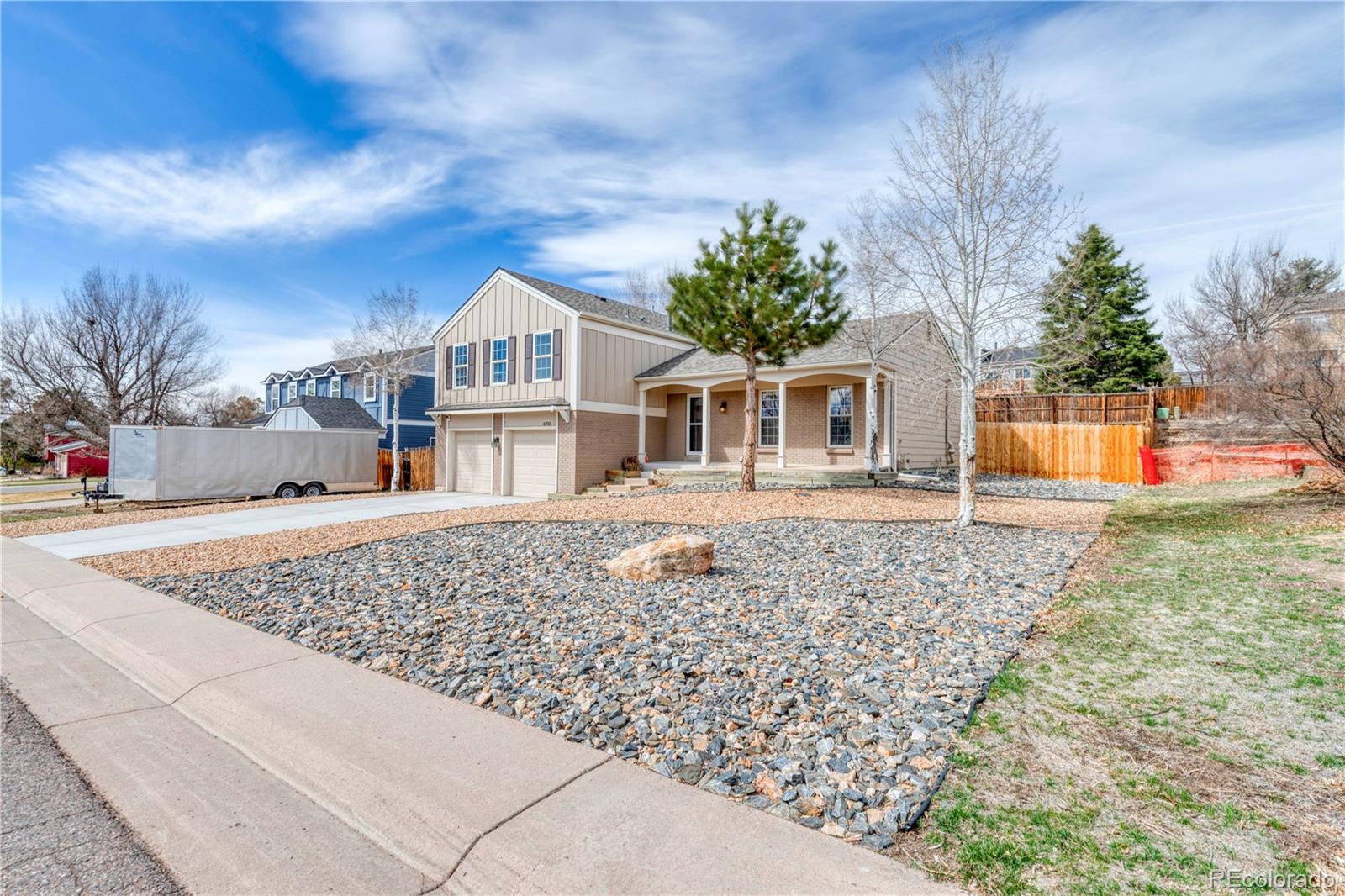 6723 East Rustic Drive Parker, CO 80138 - Photo 2 of 32 a front view of a house with garden