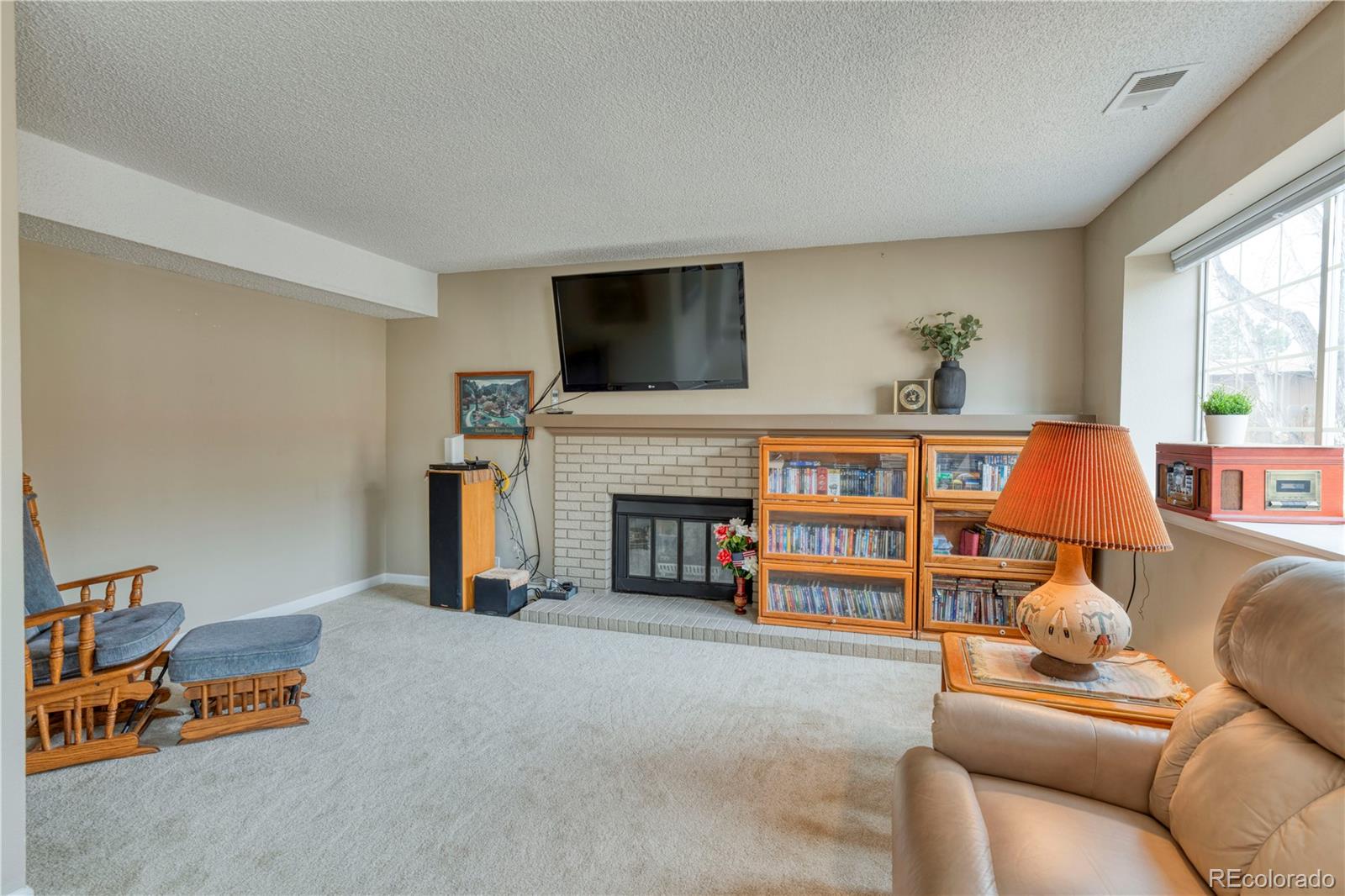 6723 East Rustic Drive Parker, CO 80138 - Photo 23 of 32 a living room with furniture fireplace and flat screen tv