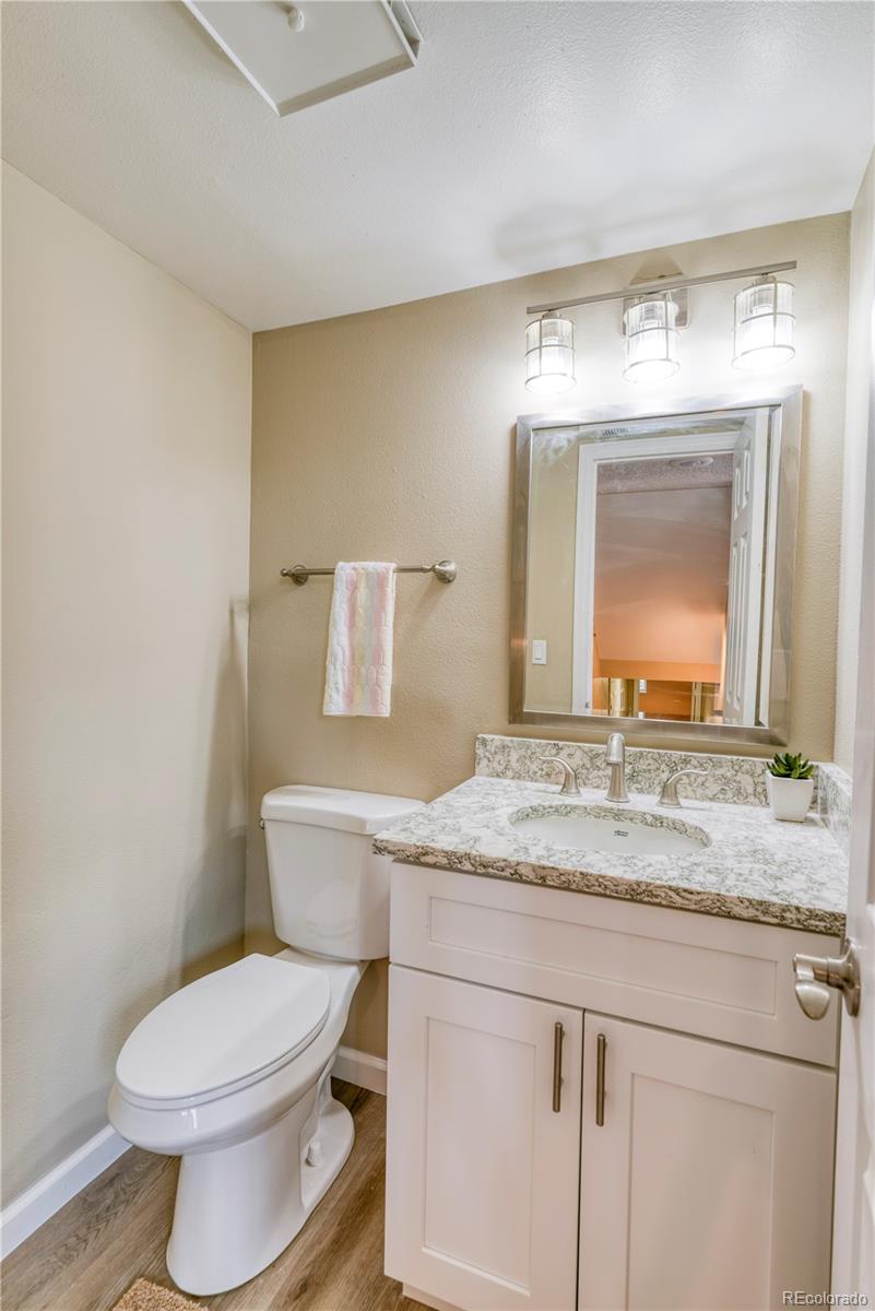 6723 East Rustic Drive Parker, CO 80138 - Photo 24 of 32 a bathroom with a granite countertop toilet sink and mirror