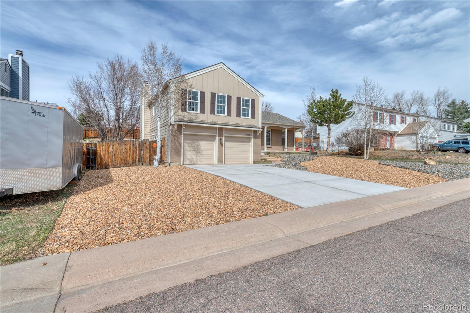 6723 East Rustic Drive Parker, CO 80138 - Photo 3 of 32 a front view of a house with a yard